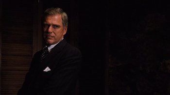Movie still from “The Godfather Part II” (1974), directed by Francis Ford Coppola – A person wearing a suit and tie; Medium shot, Over the shoulder angle