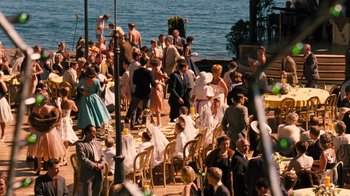 Movie still from “The Godfather Part II” (1974), directed by Francis Ford Coppola – A crowd of people standing around a lake; Extreme Wide shot, High angle