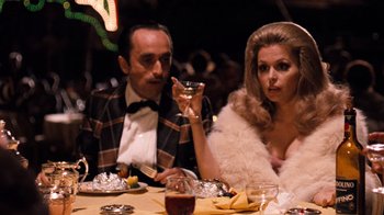 Movie still from “The Godfather Part II” (1974), directed by Francis Ford Coppola – A man and a woman sitting at a dinner table; Medium shot, Over the shoulder angle