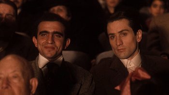 Movie still from “The Godfather Part II” (1974), directed by Francis Ford Coppola – A couple of men sitting next to each other in a room; Close Up shot, Low angle
