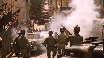 Movie still from “The Godfather Part II” (1974), directed by Francis Ford Coppola – A group of men holding guns on a city street; Wide shot, High angle