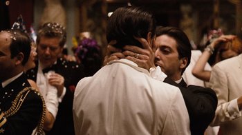 Movie still from “The Godfather Part II” (1974), directed by Francis Ford Coppola – A couple of people that are kissing in a room; Close Up shot, Over the shoulder angle