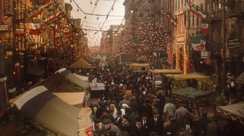 Movie still from “The Godfather Part II” (1974), directed by Francis Ford Coppola – A crowd of people walking down a street; Extreme Wide shot, High angle