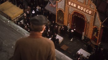 Movie still from “The Godfather Part II” (1974), directed by Francis Ford Coppola – A crowd of people standing in front of a building; Wide shot, High angle