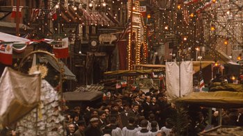 Movie still from “The Godfather Part II” (1974), directed by Francis Ford Coppola – A group of people standing in a room with lights; Extreme Wide shot, High angle