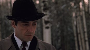 Movie still from “The Godfather Part II” (1974), directed by Francis Ford Coppola – A man wearing a suit and a hat; Close Up shot, Low angle