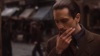 Movie still from “The Godfather Part II” (1974), directed by Francis Ford Coppola – A person wearing a suit and tie; Close Up shot, Low angle