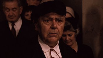 Movie still from “The Godfather Part II” (1974), directed by Francis Ford Coppola – An older man wearing a hat and a tie; Close Up shot, Low angle