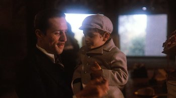 Movie still from “The Godfather Part II” (1974), directed by Francis Ford Coppola – A man and a boy in a suit and hat; Close Up shot, Low angle