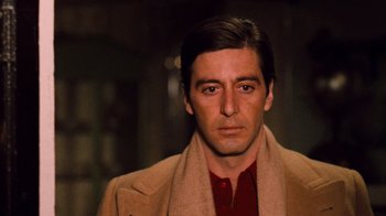 Movie still from “The Godfather Part II” (1974), directed by Francis Ford Coppola – A person wearing a suit and a scarf; Close Up shot, Low angle