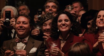 Movie still from “The Godfather Part III” (1990), directed by Francis Ford Coppola – A group of people holding drinks in their hands; Medium shot, High angle