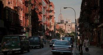 Movie still from “The Godfather Part III” (1990), directed by Francis Ford Coppola – A city street filled with lots of traffic and buildings; Extreme Wide shot, Low angle