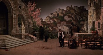 Movie still from “The Godfather Part III” (1990), directed by Francis Ford Coppola – A group of people standing in front of a mural; Extreme Wide shot, High angle