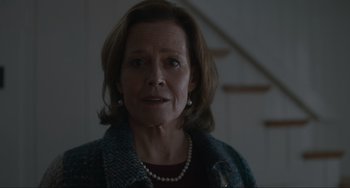 Movie still from “The Good House” (2021), directed by Maya Forbes – An older woman wearing a pearl necklace in a dark room; Close Up shot, Low angle