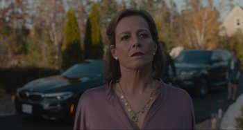 Movie still from “The Good House” (2021), directed by Maya Forbes – A person wearing a pink shirt; Close Up shot, Over the shoulder angle