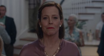 Movie still from “The Good House” (2021), directed by Maya Forbes – A person wearing a purple shirt; Close Up shot, Low angle