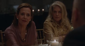 Movie still from “The Good House” (2021), directed by Maya Forbes – Two women sitting at a dinner table with a candle; Close Up shot, Over the shoulder angle