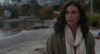 Movie still from “The Good House” (2021), directed by Maya Forbes – A woman with long dark hair wearing a green jacket; Close Up shot, Over the shoulder angle