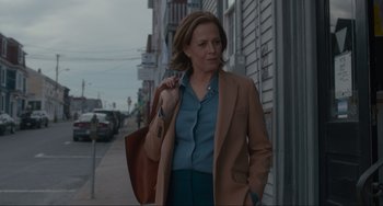Movie still from “The Good House” (2021), directed by Maya Forbes – A woman is walking down the street holding a purse; Medium shot, Over the shoulder angle