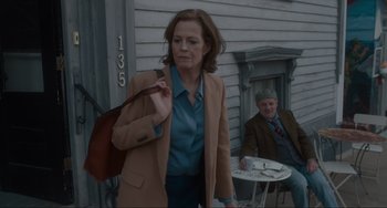 Movie still from “The Good House” (2021), directed by Maya Forbes – A woman walking down the street holding a purse; Medium shot, Over the shoulder angle