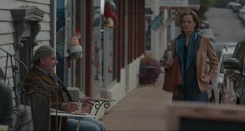 Movie still from “The Good House” (2021), directed by Maya Forbes – A woman walking down a street while holding a phone; Wide shot, Over the shoulder angle