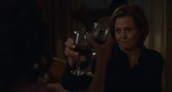 Movie still from “The Good House” (2021), directed by Maya Forbes – A woman holding up a glass of red wine; Close Up shot, Over the shoulder angle