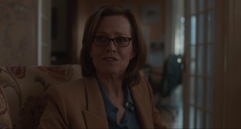 Movie still from “The Good House” (2021), directed by Maya Forbes – A person wearing glasses and a jacket; Close Up shot, Over the shoulder angle