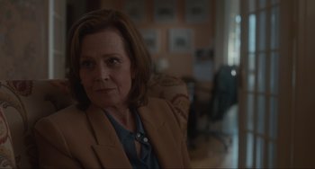 Movie still from “The Good House” (2021), directed by Maya Forbes – A person sitting in a chair in a living room; Close Up shot, Over the shoulder angle