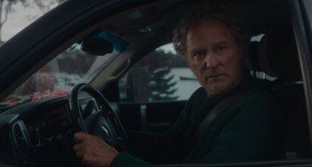 Movie still from “The Good House” (2021), directed by Maya Forbes – A man sitting in the driver's seat of a car; Close Up shot, Over the shoulder angle