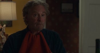 Movie still from “The Good House” (2021), directed by Maya Forbes – An older man wearing a red neck tie; Close Up shot, Over the shoulder angle