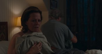 Movie still from “The Good House” (2021), directed by Maya Forbes – A woman sitting in front of a man in a room; Medium shot, Over the shoulder angle