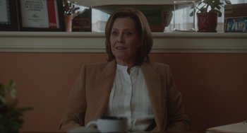 Movie still from “The Good House” (2021), directed by Maya Forbes – A woman sitting in front of a coffee cup; Medium shot, Over the shoulder angle