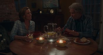 Movie still from “The Good House” (2021), directed by Maya Forbes – A man and a woman sitting at a dinner table; Medium shot, High angle