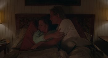 Movie still from “The Good House” (2021), directed by Maya Forbes – A man and a woman laying in bed together; Medium shot, High angle