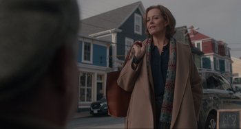 Movie still from “The Good House” (2021), directed by Maya Forbes – A woman is walking down the street holding a purse; Medium shot, Over the shoulder angle