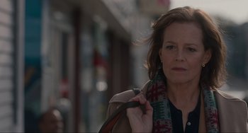 Movie still from “The Good House” (2021), directed by Maya Forbes – A person holding a scarf; Close Up shot, Over the shoulder angle