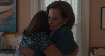 Movie still from “The Good House” (2021), directed by Maya Forbes – A woman hugging a young girl in a living room; Close Up shot, Over the shoulder angle