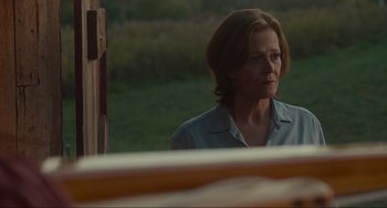 Movie still from “The Good House” (2021), directed by Maya Forbes – A woman in a blue shirt is looking out a window; Close Up shot, Over the shoulder angle