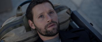 Movie still from “The Good Neighbor” (2022), directed by Stephan Rick – A person with a beard; Close Up shot, High angle