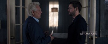 Movie still from “The Good Neighbor” (2022), directed by Stephan Rick – Two men in a room talking to each other; Medium shot, Over the shoulder angle