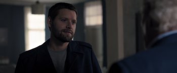 Movie still from “The Good Neighbor” (2022), directed by Stephan Rick – A person wearing a jacket; Close Up shot, Over the shoulder angle