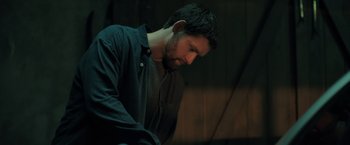 Movie still from “The Good Neighbor” (2022), directed by Stephan Rick – A person wearing a shirt and a tie; Medium shot, Low angle