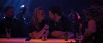 Movie still from “The Good Neighbor” (2022), directed by Stephan Rick – A man and a woman sitting at a table; Medium shot, Over the shoulder angle