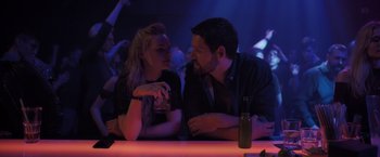 Movie still from “The Good Neighbor” (2022), directed by Stephan Rick – A man and a woman sitting at a bar; Medium shot, Over the shoulder angle