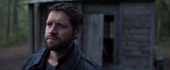 Movie still from “The Good Neighbor” (2022), directed by Stephan Rick – A person wearing a jacket; Close Up shot, Over the shoulder angle