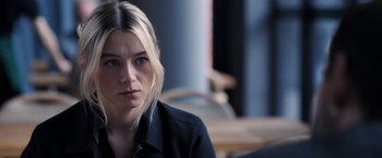 Movie still from “The Good Neighbor” (2022), directed by Stephan Rick – A person wearing a black shirt; Close Up shot, Over the shoulder angle