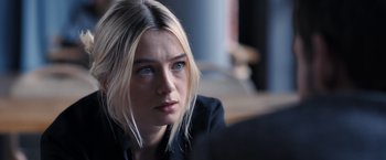 Movie still from “The Good Neighbor” (2022), directed by Stephan Rick – A person sitting in front of a window; Close Up shot, Over the shoulder angle