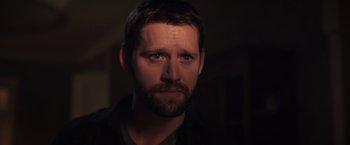 Movie still from “The Good Neighbor” (2022), directed by Stephan Rick – A person with a beard; Close Up shot, Over the shoulder angle