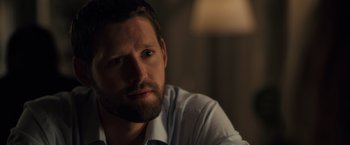 Movie still from “The Good Neighbor” (2022), directed by Stephan Rick – A person wearing a shirt and tie; Close Up shot, Over the shoulder angle