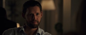 Movie still from “The Good Neighbor” (2022), directed by Stephan Rick – A person with a beard; Close Up shot, Over the shoulder angle